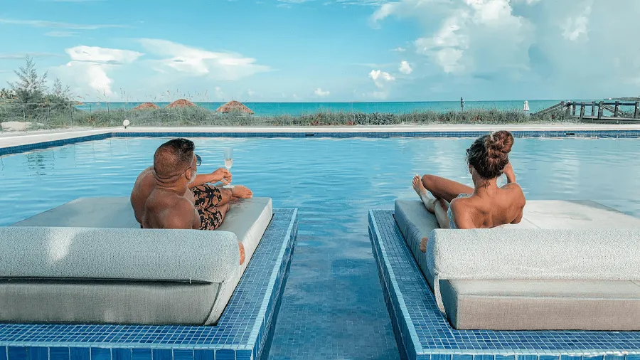 Ett par vid en pool i Bahamas, ett av många romantiska resmål.